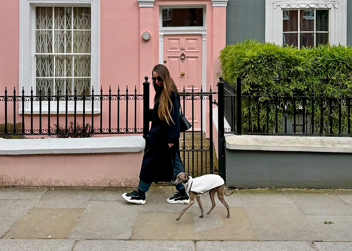 Nina walking an Italian Greyhound named Lola in Notting Hill with a pink building in the background